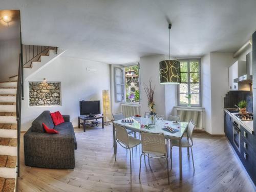 a living room with a table and a couch at VILLA VINICIA, pool, jacuzzi, airco in Domaso
