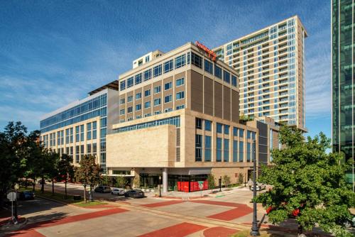 a tall building with a lot of windows at Canopy By Hilton Dallas Uptown in Dallas