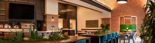 a restaurant with tables and chairs in a building at Canopy By Hilton Dallas Uptown in Dallas