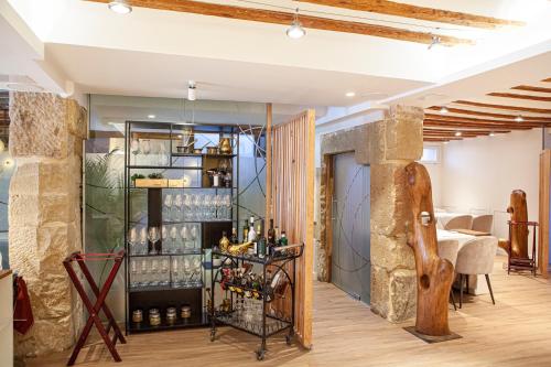 a tasting room with wine bottles on a shelf at Hotel El Doncel in Sigüenza