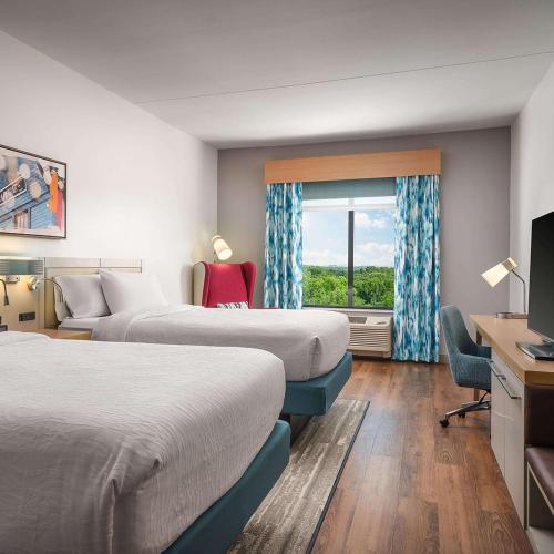 a hotel room with two beds and a window at Hilton Garden Inn Grapevine At Silverlake Crossing, Tx in Grapevine