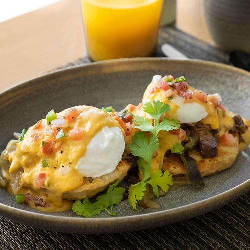 a plate of food with eggs on top of toast at Hilton Garden Inn Grapevine At Silverlake Crossing, Tx in Grapevine