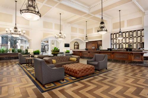 a lobby with couches and chairs in a building at Embassy Suites Dallas - DFW International Airport South in Irving