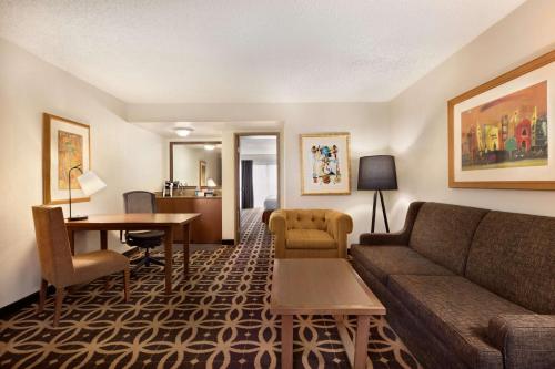 a living room with a couch and a table at Embassy Suites Dallas - DFW International Airport South in Irving