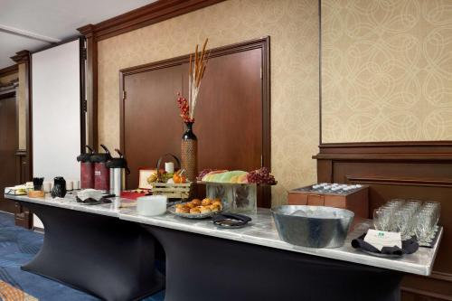 a buffet in a hotel room with food on a table at Embassy Suites Dallas - DFW International Airport South in Irving