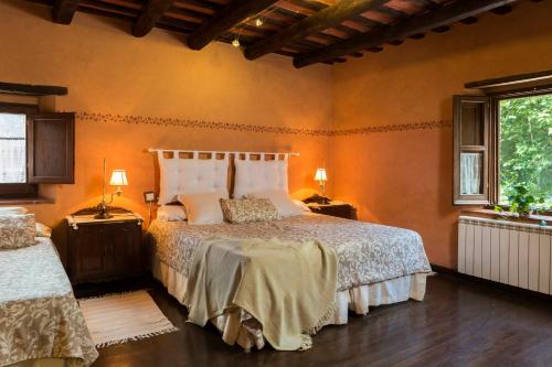 a bedroom with a bed and two lamps and a window at Casa rural Can Jepet in La Cellera de Ter