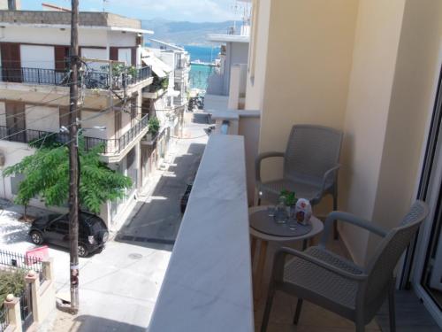 a balcony with a table and chairs and a view of a city at Katerina sitia apartments 1 in Sitia
