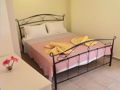 a bedroom with a bed with yellow towels on it at Katerina sitia apartments 1 in Sitia