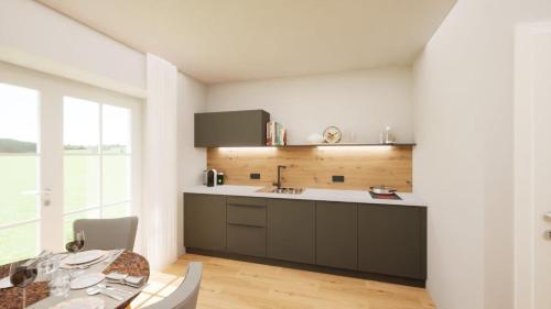 a kitchen with a sink and a table in a room at Echo am See in Gmunden