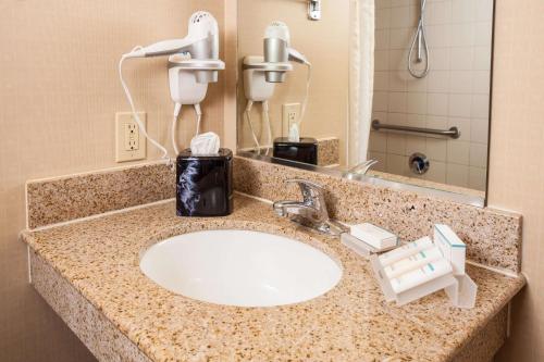 a bathroom counter with a sink with a phone on it at Hilton Garden Inn El Paso University in El Paso