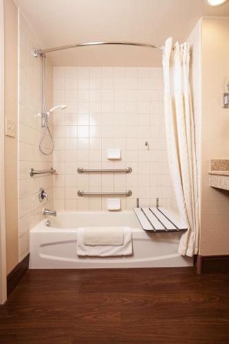 a bathroom with a bath tub with a shower at Hilton Garden Inn El Paso University in El Paso