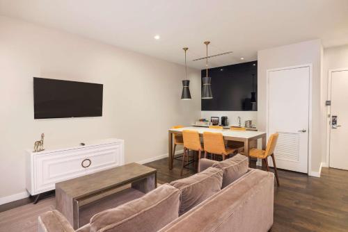 a living room with a couch and a table at The Statler Dallas, Curio Collection By Hilton in Dallas