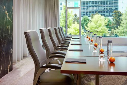 a long row of chairs and a long table in a room at The Statler Dallas, Curio Collection By Hilton in Dallas