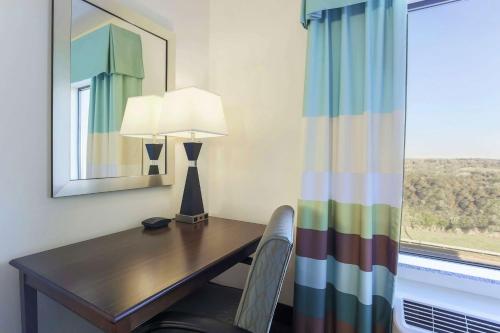 a desk with a lamp and a chair next to a window at Hampton Inn & Suites Wheeling - The Highlands in Triadelphia