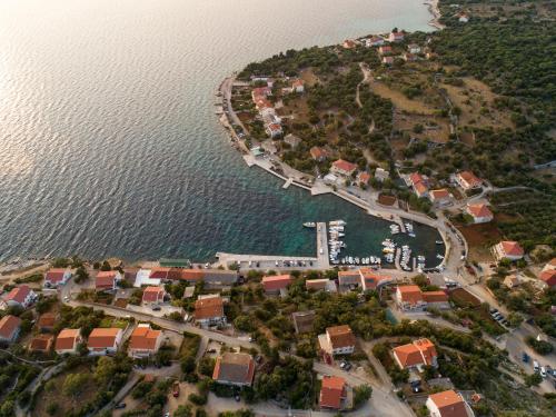 an aerial view of a small town next to the water at BRAND NEW Stone house MARCELA, 3 double bedrooms, pool in Lun