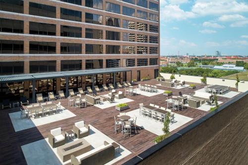 a rendering of the rooftop patio of a building at Hilton Houston Plaza/Medical Center in Houston