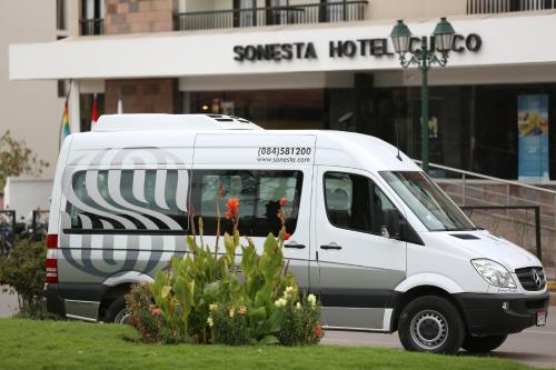 a white van parked in front of a building at Sonesta Hotel Cusco in Cusco