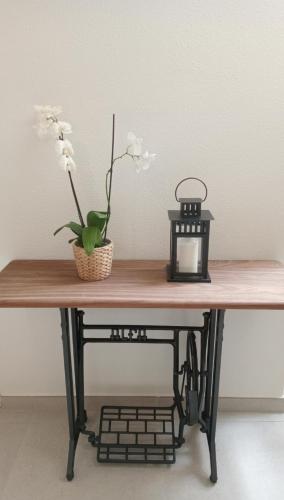 a table with a black lantern and flowers on it at El Chisco in San Cosme