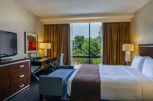 a hotel room with a bed and a desk and a television at Doubletree by Hilton Los Angeles Downtown in Los Angeles