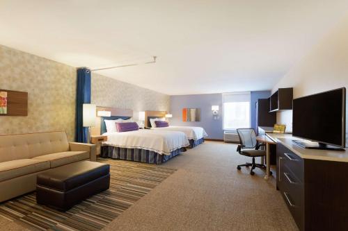 a hotel room with a bed and a desk at Home2 Suites by Hilton Midland in Midland