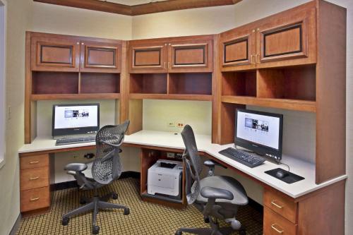 an office with two computer desks and two monitors at Hilton Garden Inn Chicago/Midway Airport in Chicago