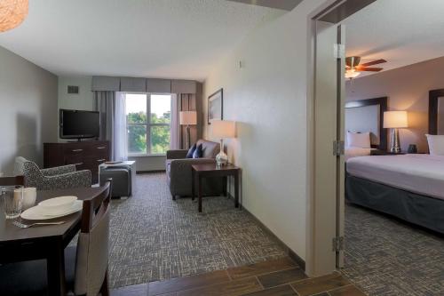 a hotel room with a bed and a living room at Homewood Suites by Hilton Southwind - Hacks Cross in Memphis