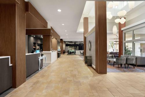 an office lobby with a long hallway with tables and chairs at Hilton Garden Inn New Orleans Convention Center in New Orleans