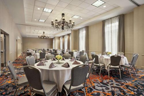 a conference room with tables and chairs and a chandelier at Hilton Garden Inn New Orleans Convention Center in New Orleans