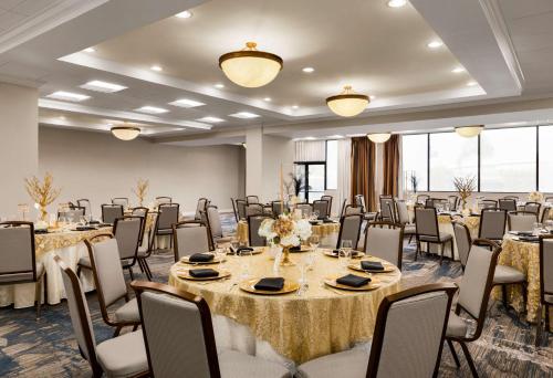 a conference room with tables and chairs and tablesktop at DoubleTree by Hilton New Orleans Airport in Kenner