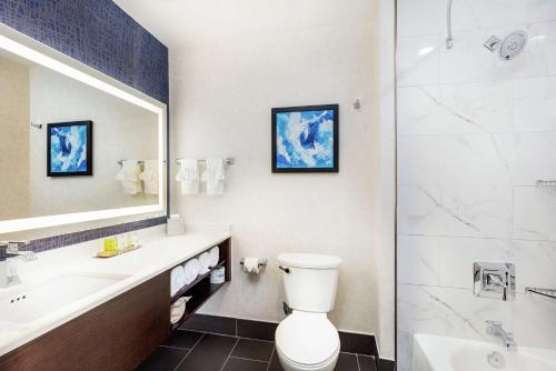 a bathroom with a toilet and a sink and a shower at Doubletree By Hilton Pomona in Pomona