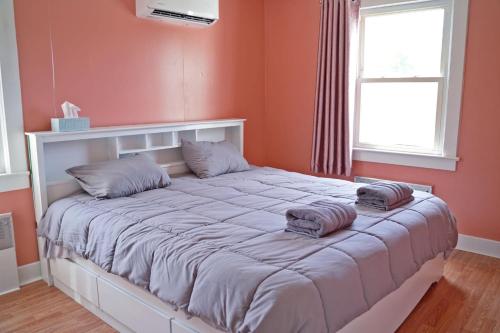 a bedroom with a large bed with two pillows on it at Tranquil cozy Apartment in charming area in Albany