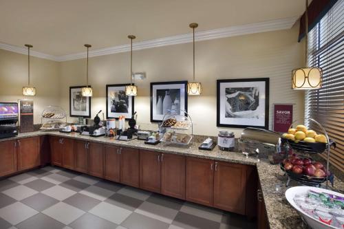 a lobby with a counter with fruit on it at Hampton Inn West Palm Beach Central Airport in West Palm Beach