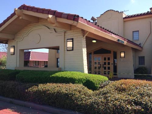 a house with an archway in front of a yard at Motel 6-Monroe, LA in Monroe