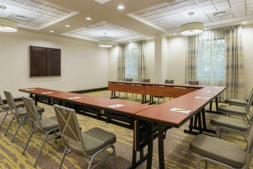 a conference room with a large table and chairs at Hilton Garden Inn West Palm Beach Airport in West Palm Beach