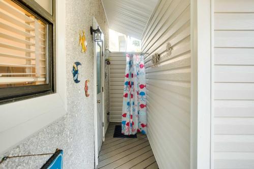 a hallway leading to a home with aqualives at St Simons Island Condo with Deck and Outdoor Shower in Saint Simon Mills