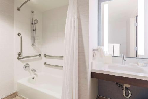 a bathroom with a tub and a sink and a shower at Hilton Garden Inn Reno in Reno