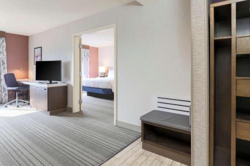 a hotel room with a bed and a desk at Hilton Garden Inn Reno in Reno