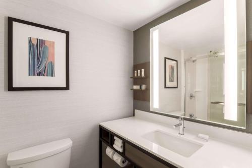 a bathroom with a white sink and a mirror at Hilton Garden Inn Reno in Reno