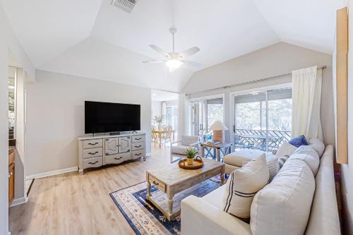 a living room with a couch and a tv at Turtle Cove 5546 in Kiawah Island