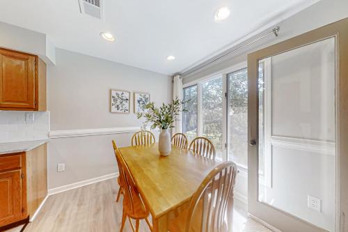 a dining room with a table and chairs and a window at Turtle Cove 5546 in Kiawah Island