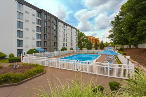 a swimming pool with a white fence around a building at DoubleTree by Hilton Washington Meadow Lands Casino Area in Washington