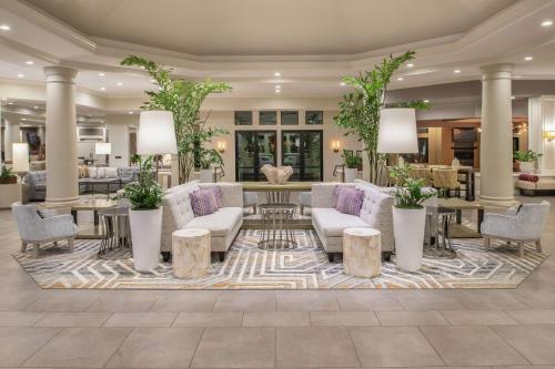 a lobby with couches and tables and plants at Hilton San Diego/Del Mar in San Diego