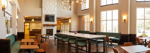 a restaurant with a table and chairs and a fireplace at Hampton Inn & Suites Boerne in Boerne