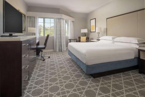 a hotel room with a bed and a flat screen tv at Hilton San Diego/Del Mar in San Diego