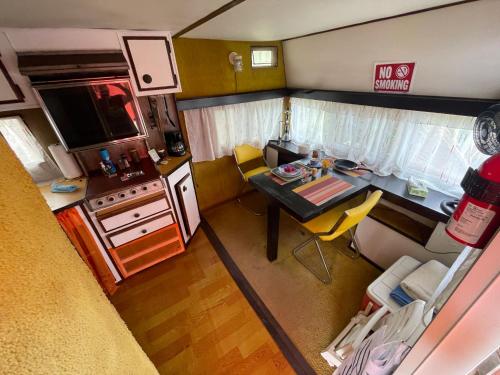 an aerial view of a small kitchen with a table in a caravan at Backpack Cabin A 49149 in Oranjestad