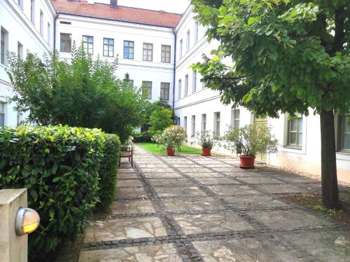 a walkway in the courtyard of a building at Lakeside Heritage Apartment in Balatonfüred