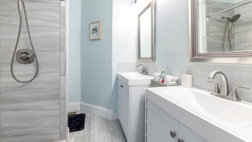 a white bathroom with a sink and a shower at Classic 1 Bedroom Apt in Midtown, ATL in Atlanta
