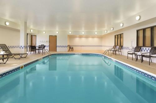 a large swimming pool with chairs and tables at Hampton Inn San Angelo in San Angelo