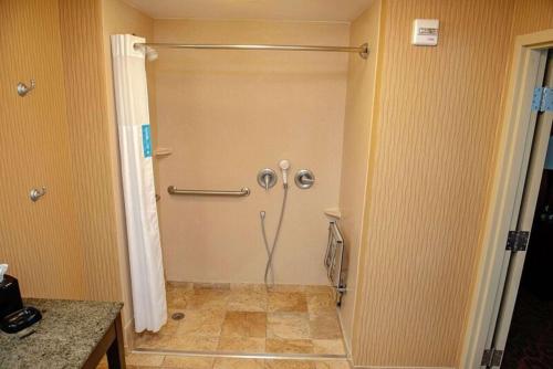 a bathroom with a shower in the corner of a room at Hampton Inn & Suites Bradenton in Bradenton