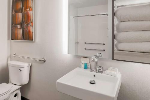 a white bathroom with a sink and a toilet at Hampton Inn & Suites Windsor-Sonoma Wine Country in Windsor